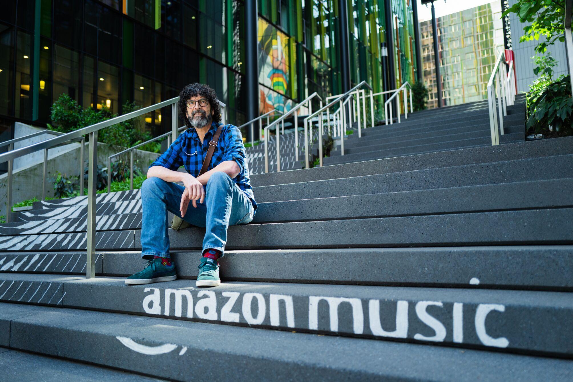 Sam sitting on Amazon Music steps 
